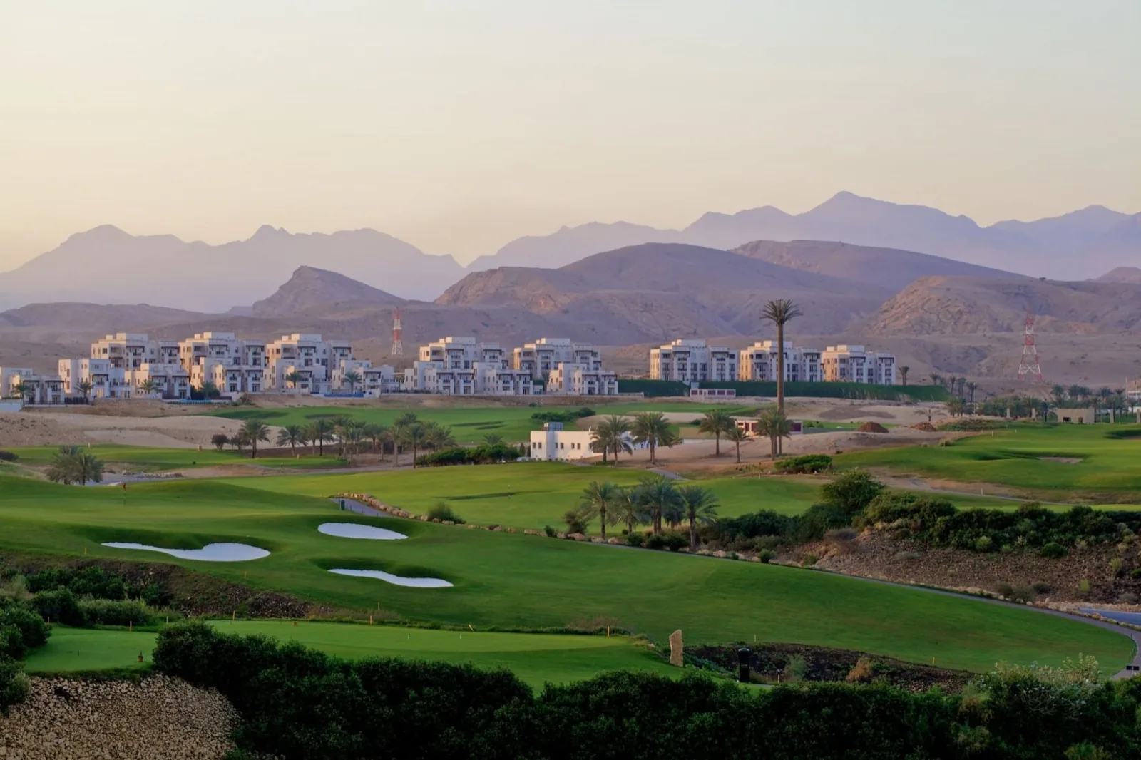 Muscat Hills golf course with the residential buildings and the Al Hajar mountains behind